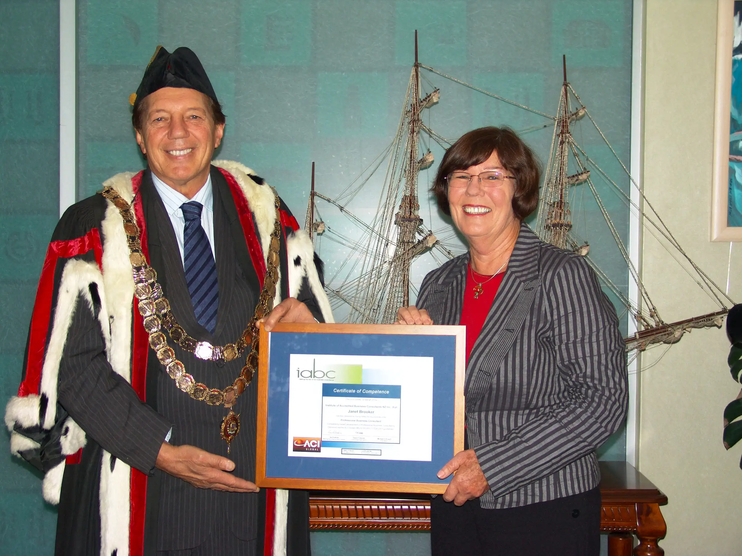 Sir Tim Shadbolt presenting Janet with her Professional Business Consultant qualification